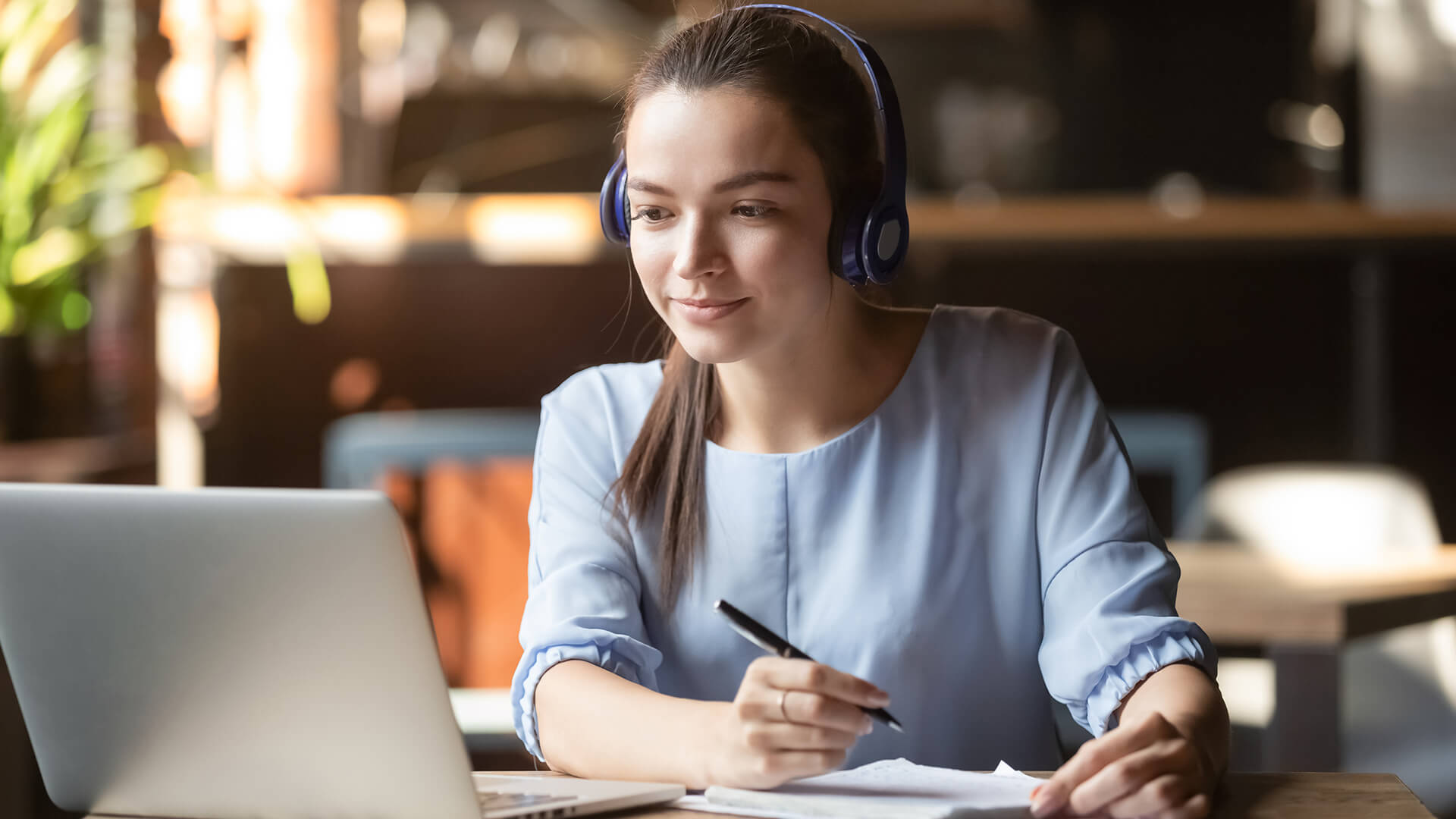 Female teenager attending online class on her laptop